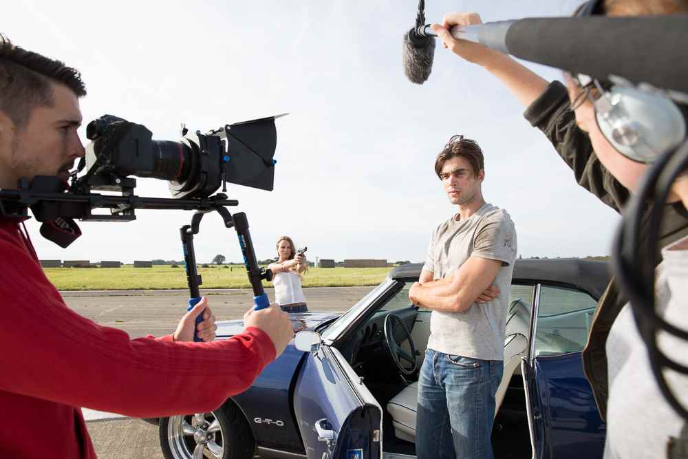 Film crew and actors on set shooting a film