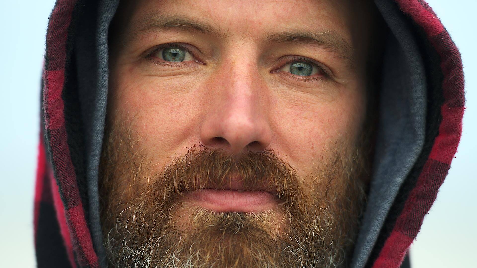 Close up portrait of man with beard and red checker hood - structure effect before