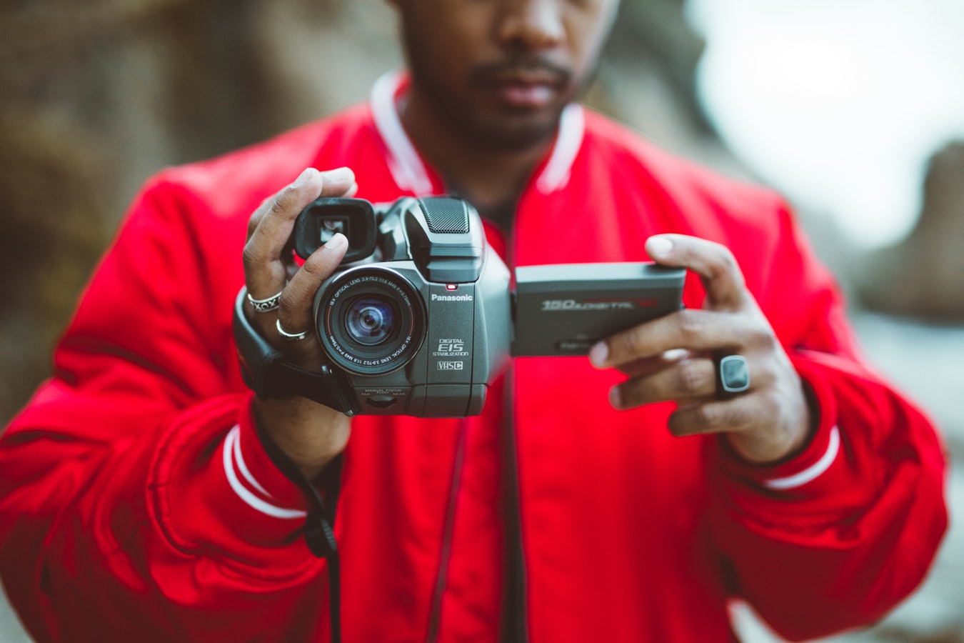 Guy holding camcorder toward camera - choosing the best video camera for beginners