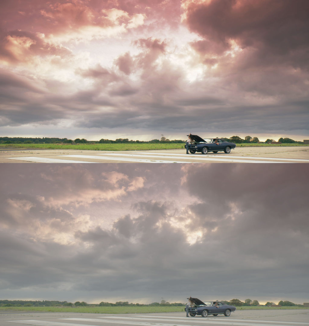 Graded vs Ungraded -  Wide shot of girl looking under car bonnet on airfield while man leans out of window