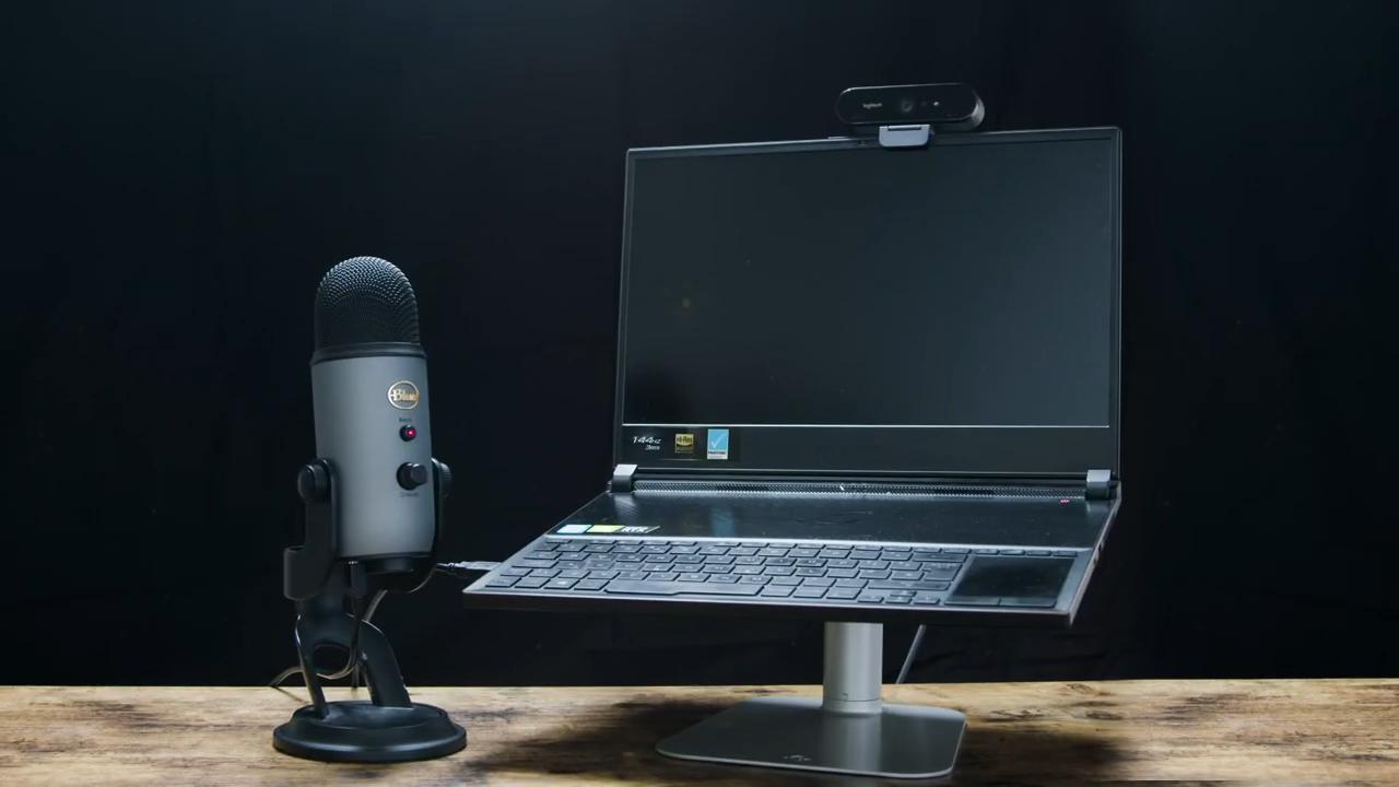 Streaming setup with laptop, webcam, and Yeti mic