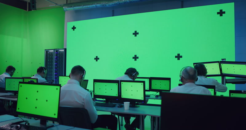 Still from a stock video showing a green screen ready mission control room.
