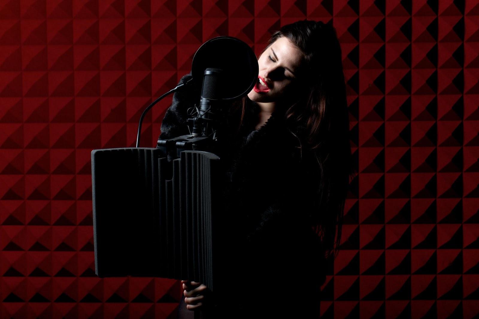 Singer in studio with dark red background