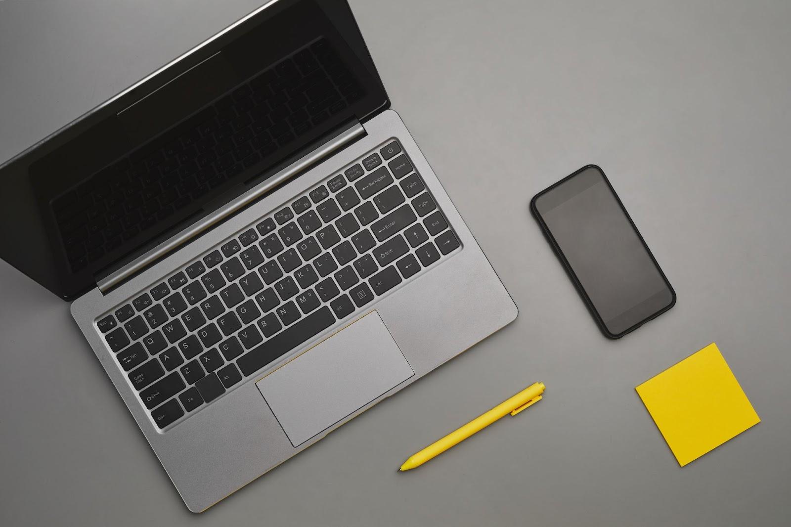 Laptop and smartphone laid out on a minimalist office desk