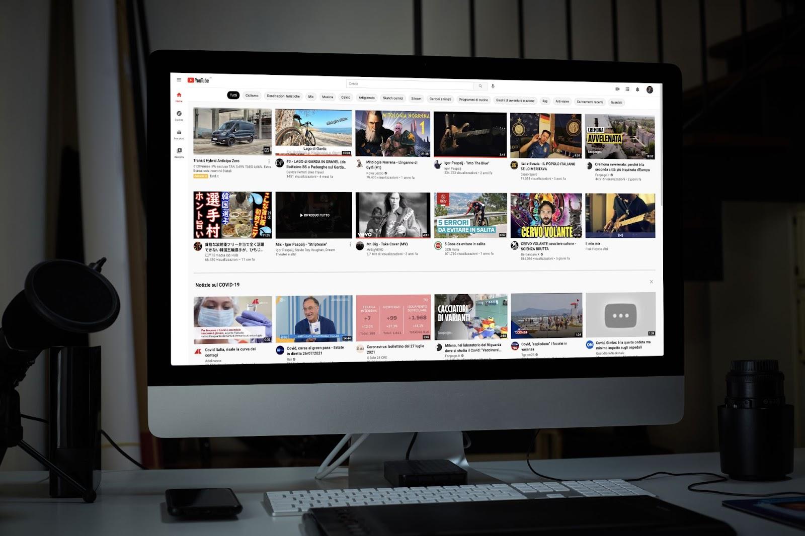 The YouTube homepage on a large iMac screen